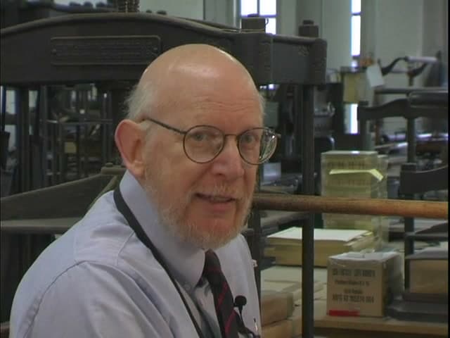 Sam Ellenport looking toward the camera while teaching in his bookbinding workshop