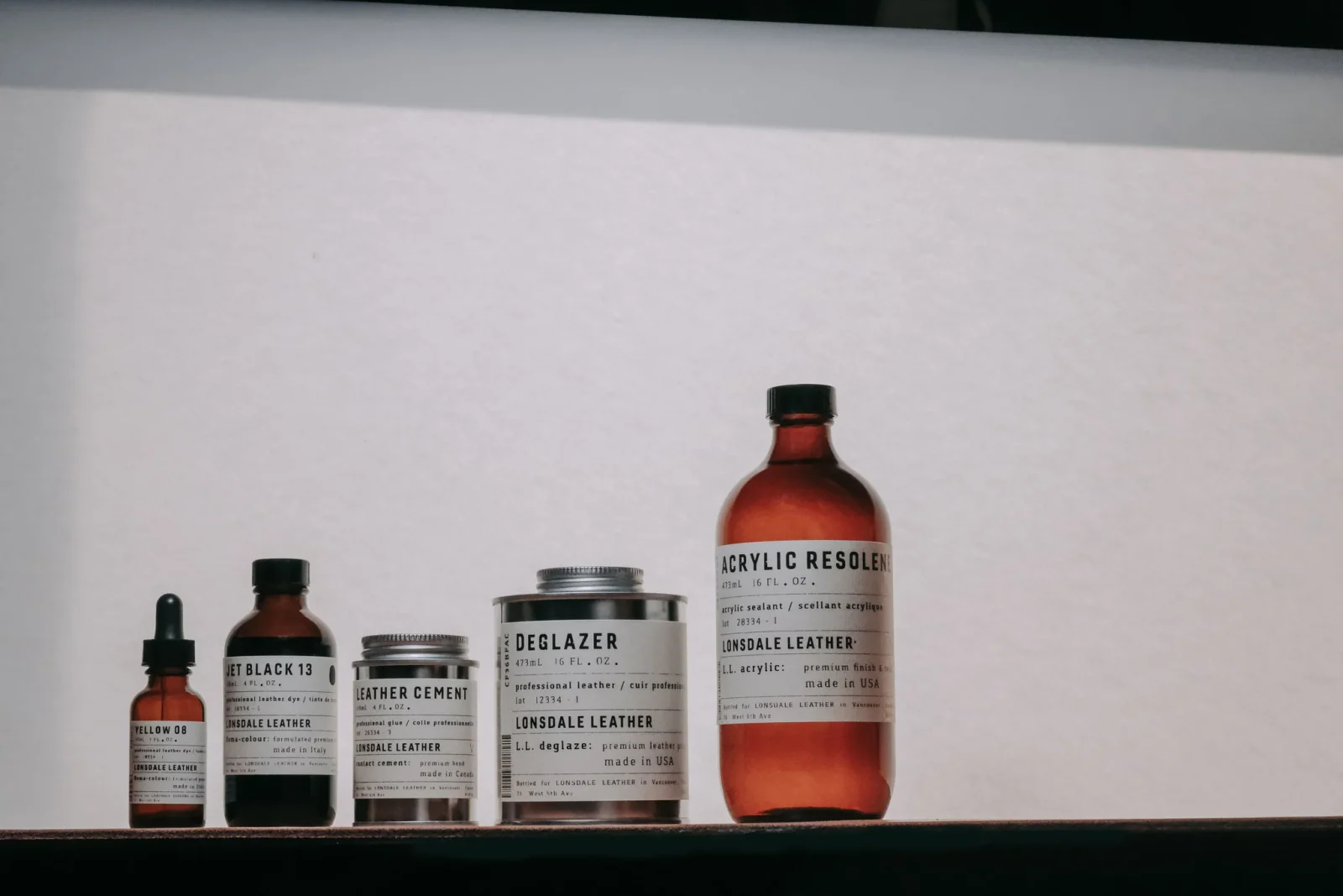 Leather finishing supplies arranged on a shelf
