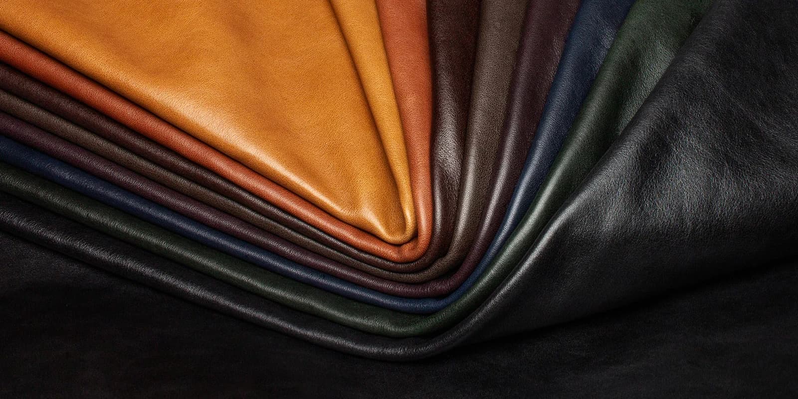 Folded upholstery leathers arranged in a fan of warm and dark colors
