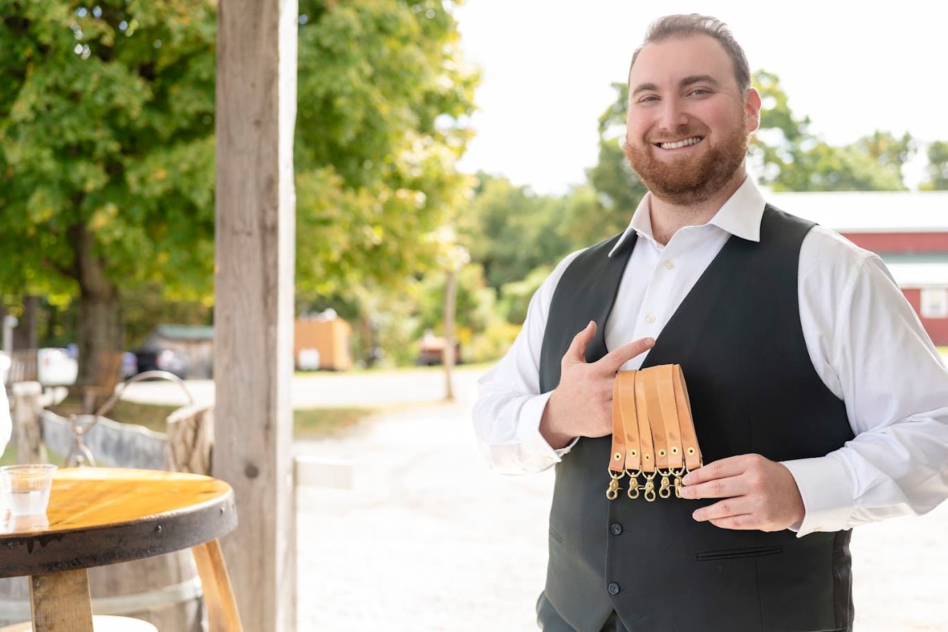 Jake Francis holding a set of handmade leather key straps.