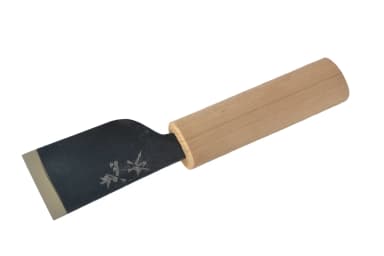 Japanese skiving knife with a dark steel blade and magnolia wood handle